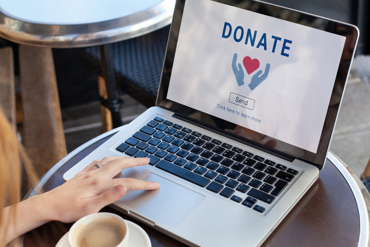 Australian taxpayer making an online donation to a registered charity using a laptop. Australian taxpayer making an online donation to a registered charity using a laptop.
