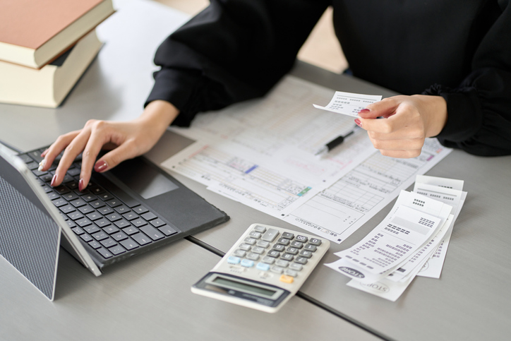 Person checking receipts, tax paperwork and expenses before lodging an Australian tax return to avoid common tax mistakes. Person checking receipts, tax paperwork and expenses before lodging an Australian tax return to avoid common tax mistakes.