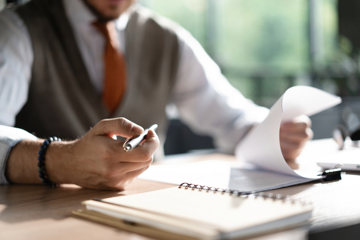 A professional Australian executor or legal personal representative reviewing estate administration documents, tax paperwork and financial records at a desk. A professional Australian executor or legal personal representative reviewing estate administration documents, tax paperwork and financial records at a desk.