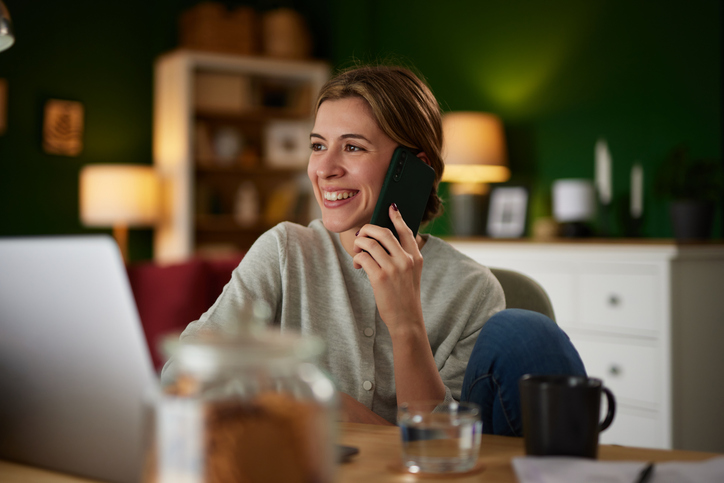Employee working from home using smartphone for work communication