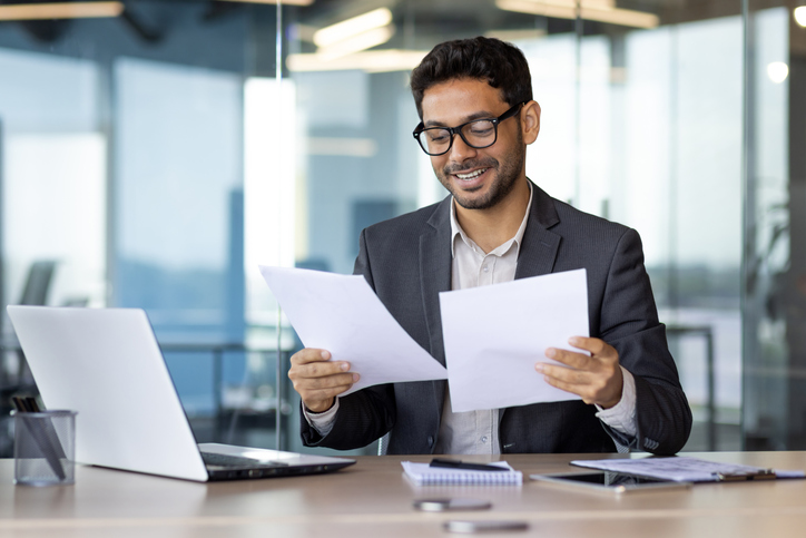 Professional reviewing tax documents before amending an Australian tax return. Professional reviewing tax documents before amending an Australian tax return.